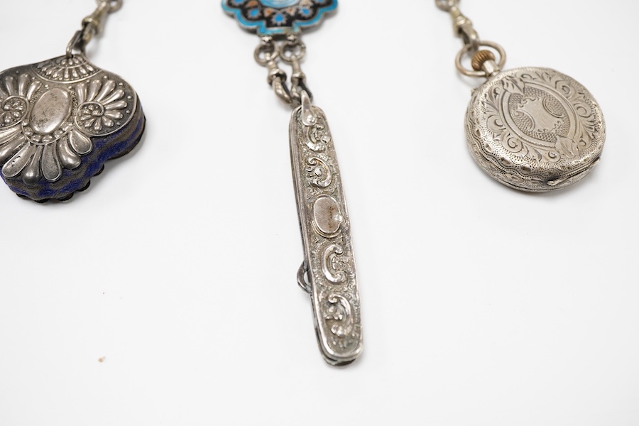 An enamel chatelaine, late 19th/early 20th century, composed of metal plaques applied with foliate patterns in blue, black and red enamel, indistinctly stamped maker's marks, suspending a silver pin cushion and a silver